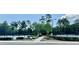 Scenic view of community tennis courts surrounded by lush greenery and mature trees at 402 Ravenshill Way, Deland, FL 32724