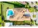 Aerial view of home with manicured lawn, pool, and circular driveway at 4065 Isabella Cir, Windermere, FL 34786