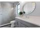 Modern bathroom featuring a glass walk-in shower, a decorative mirror and neutral finishes at 4065 Isabella Cir, Windermere, FL 34786