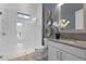 Elegant bathroom with glass shower, gray vanity, and stylish decorative wall art at 4065 Isabella Cir, Windermere, FL 34786
