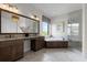 Luxurious bathroom featuring dual sinks, soaking tub, and glass-enclosed shower at 4065 Isabella Cir, Windermere, FL 34786