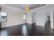 Spacious bedroom with dark hardwood floors, detailed trim work, and elegant light fixture at 4065 Isabella Cir, Windermere, FL 34786