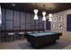 Entertaining bonus room features a pool table, bar seating, and designer lighting at 4065 Isabella Cir, Windermere, FL 34786