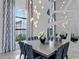 Formal dining room featuring a large dining table, modern chandelier, and unique geometric mirrors at 4065 Isabella Cir, Windermere, FL 34786
