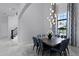 Bright dining room featuring modern light fixture, dining table, and window views at 4065 Isabella Cir, Windermere, FL 34786