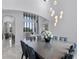 Elegant dining area with a long table, designer chairs, and an open view into the home's living spaces at 4065 Isabella Cir, Windermere, FL 34786