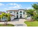 Elegant home showcasing a beautifully designed facade, manicured lawn, and a welcoming driveway entrance at 4065 Isabella Cir, Windermere, FL 34786