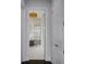 Hallway view into modern bathroom, showcasing white tile flooring and glass enclosed shower at 4065 Isabella Cir, Windermere, FL 34786