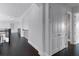 Bright hallway with dark hardwood floors, white trim, and staircase to the next level at 4065 Isabella Cir, Windermere, FL 34786