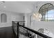 Upstairs hallway with decorative hanging light, showcasing architecture and natural light at 4065 Isabella Cir, Windermere, FL 34786