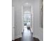 Hallway with dark wood floors, an arched entrance, and view to the bedroom at 4065 Isabella Cir, Windermere, FL 34786