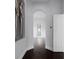 Hallway with views of a bathroom and light-filled living space with dark hardwood floors at 4065 Isabella Cir, Windermere, FL 34786