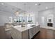 Open-concept kitchen with stainless steel appliances, quartz countertops, and an island at 4065 Isabella Cir, Windermere, FL 34786