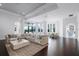 Spacious living room with plush sectional sofa, large windows, and elegant decor at 4065 Isabella Cir, Windermere, FL 34786