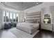 Luxurious main bedroom featuring large windows, a seating area, and stylish decor at 4065 Isabella Cir, Windermere, FL 34786
