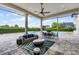 Covered patio with columns features an outdoor lounge, dining set, and pool view at 4065 Isabella Cir, Windermere, FL 34786