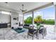 Inviting covered patio with fireplace, dining area, and outdoor kitchen at 4065 Isabella Cir, Windermere, FL 34786