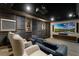 Movie theater with large projection screen, comfortable seating, and custom wall and ceiling details at 4065 Isabella Cir, Windermere, FL 34786