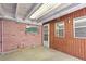 Back porch with brick wall, vinyl siding, and windows allowing natural light at 4279 Bomber Rd, Bartow, FL 33830