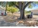 Expansive backyard featuring mature trees, sheds, and ample space for outdoor activities and relaxation at 4279 Bomber Rd, Bartow, FL 33830