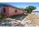 View of the brick home and spacious yard featuring mature trees at 4279 Bomber Rd, Bartow, FL 33830