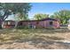 Back exterior view of brick home with small patch of grass at 4279 Bomber Rd, Bartow, FL 33830