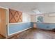 Unfinished basement featuring multicolored tile flooring, blue wainscoting and a small window at 4279 Bomber Rd, Bartow, FL 33830