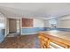 Unfinished basement with multicolored tile flooring, blue wainscoting, and a large wooden workstation at 4279 Bomber Rd, Bartow, FL 33830