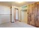 Cozy bedroom featuring light-colored carpet, wood paneled wall and closet with an attached open closet at 4279 Bomber Rd, Bartow, FL 33830