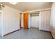 Small bedroom with blue tile flooring, paneled walls, and a petite closet at 4279 Bomber Rd, Bartow, FL 33830