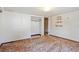 Bedroom with open closet, mounted shelves and patterned wallpaper, a blend of practicality and classic design at 4279 Bomber Rd, Bartow, FL 33830