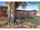 Exterior home with a mature tree, well-maintained lawn, and unique cinder block landscape feature at 4279 Bomber Rd, Bartow, FL 33830