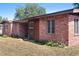 Exterior view of a brick home and well-maintained yard, offering a welcoming curb appeal at 4279 Bomber Rd, Bartow, FL 33830