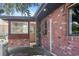 Exterior showcasing a brick home, screen door and well-maintained lawn at 4279 Bomber Rd, Bartow, FL 33830