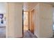 Hallway view featuring a bathroom with a toilet and a doorway leading into another room at 4279 Bomber Rd, Bartow, FL 33830