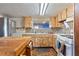 A full view of the kitchen with mosaic backsplash, tile countertops, and a large wooden workstation at 4279 Bomber Rd, Bartow, FL 33830