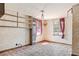 Living room featuring built-in shelving, retro wallpaper, and a vintage pendant light at 4279 Bomber Rd, Bartow, FL 33830