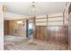 Living room with paneled walls, carpet flooring, built-in shelving, and vintage AC unit at 4279 Bomber Rd, Bartow, FL 33830