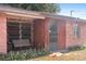 Enclosed porch with swing bench and a mix of jalousie and standard windows at 4279 Bomber Rd, Bartow, FL 33830