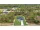 An aerial view showcasing a newly built home, complemented by a well-maintained lawn and natural surroundings at 4364 Sw 172Nd Street Rd, Ocala, FL 34473