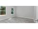 Sunlit bedroom showcasing natural light from two windows and wood-look flooring at 4364 Sw 172Nd Street Rd, Ocala, FL 34473