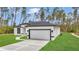 Modern single-Gathering home with a two-car garage, well-manicured lawn and green grass at 4364 Sw 172Nd Street Rd, Ocala, FL 34473