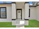 Inviting entryway to this single-Gathering home featuring decorative columns and black trim at 4364 Sw 172Nd Street Rd, Ocala, FL 34473