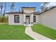 The inviting front of a single-Gathering home featuring black trim and a manicured lawn at 4364 Sw 172Nd Street Rd, Ocala, FL 34473