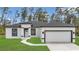 Inviting single-Gathering home featuring black trim and an attached two-car garage at 4364 Sw 172Nd Street Rd, Ocala, FL 34473