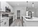 Bright kitchen with quartz counters, modern white cabinetry, stainless steel appliances, and a stylish backsplash at 4364 Sw 172Nd Street Rd, Ocala, FL 34473