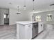 A spacious kitchen with quartz countertops, a large island, modern fixtures, and wood-look floors at 4364 Sw 172Nd Street Rd, Ocala, FL 34473