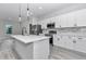 Modern kitchen with stainless steel appliances, quartz countertops, white cabinetry, and an eat-in island at 4364 Sw 172Nd Street Rd, Ocala, FL 34473
