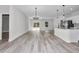 Open concept living area featuring stylish wood-look flooring, modern lighting, and views of the kitchen at 4364 Sw 172Nd Street Rd, Ocala, FL 34473