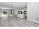 Spacious open living area with durable wood-look flooring, modern lighting, and ample natural light at 4364 Sw 172Nd Street Rd, Ocala, FL 34473